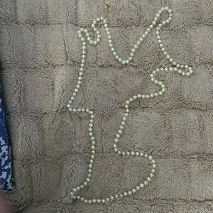 Faux pearl necklace 56 inches.  Knots between each.